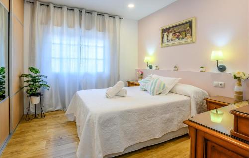 a bedroom with a bed with two pillows on it at Awesome Home In Mlaga With 2 Bedrooms And Wifi in Málaga