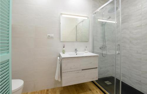 a white bathroom with a sink and a shower at Awesome Home In Mlaga With 2 Bedrooms And Wifi in Málaga