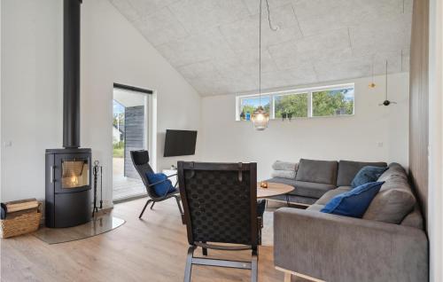 a living room with a couch and a fireplace at Awesome Home In Tarm With Kitchen in Tarm