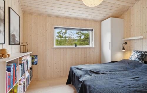 a bedroom with a bed and a window at Cozy Home In Fjerritslev With Kitchen in Slettestrand