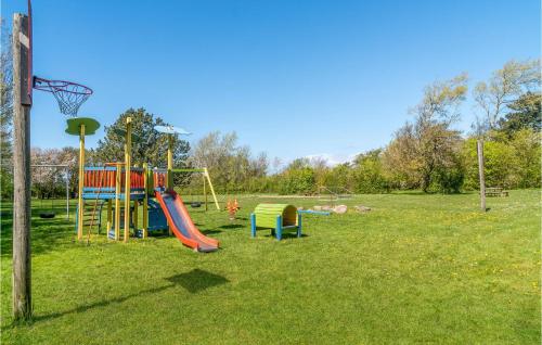 a playground with a slide and a basketball hoop at 4 Bedroom Beautiful Home In Slagelse in Slagelse
