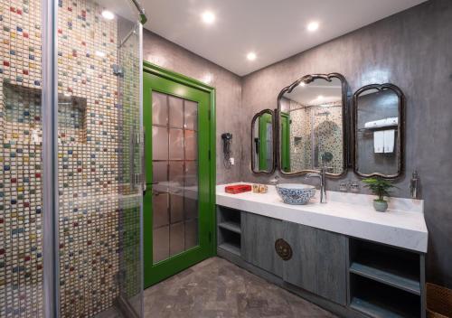 a bathroom with a shower and a green door at Hotel Cote Cour Deductive Beijing - Quadrangle close to Tiananmen Square & Forbidden City & Nanluoguxiang, Walk to Wangfujing, English speaking, Free WiFi, Free Laundry, Free Wonton & Noodles with Tour ticket service, Free selfies with ancient costume in Beijing