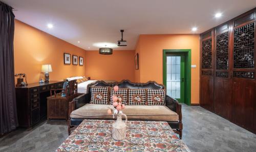 a living room with a couch and a table at Hotel Cote Cour Deductive Beijing - Quadrangle close to Tiananmen Square & Forbidden City & Nanluoguxiang, Walk to Wangfujing, English speaking, Free WiFi, Free Laundry, Free Wonton & Noodles with Tour ticket service, Free selfies with ancient costume in Beijing