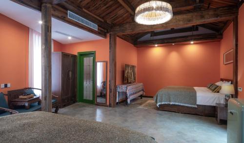a bedroom with two beds in a room with orange walls at Hotel Cote Cour Deductive Beijing - Quadrangle close to Tiananmen Square & Forbidden City & Nanluoguxiang, Walk to Wangfujing, English speaking, Free WiFi, Free Laundry, Free Wonton & Noodles with Tour ticket service, Free selfies with ancient costume in Beijing