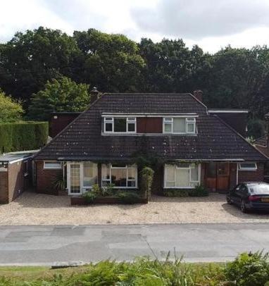a house with a car parked in front of it at Abacus Bed and Breakfast, Blackwater, Hampshire in Camberley