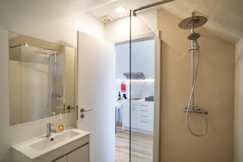 a bathroom with a shower and a sink at Pero in Blue House in Jardim do Mar
