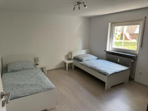 a bedroom with two beds and a window at L8 Street - Leimen - Basement floor in Leimen