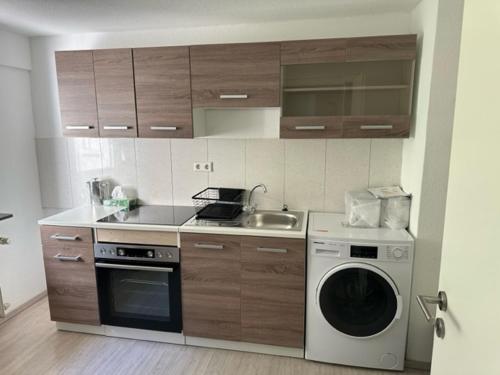 a kitchen with a washing machine and a sink at L8 Street - Leimen - Basement floor in Leimen