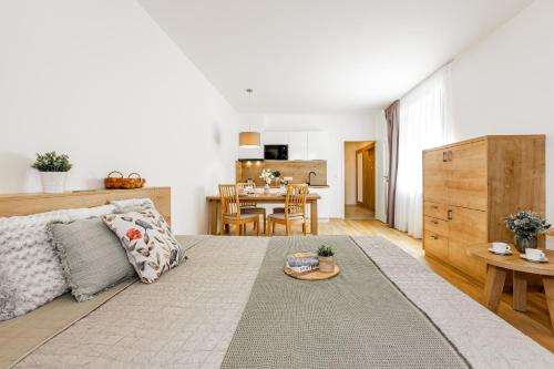 a living room with a bed and a dining room at KORZO LIPNO 2 in Lipno nad Vltavou