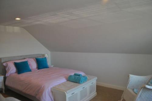 a bedroom with a bed with blue and pink pillows at Merchants House- stunning seaview period home in Anstruther