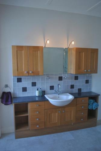 a bathroom with a sink and a mirror at Merchants House- stunning seaview period home in Anstruther