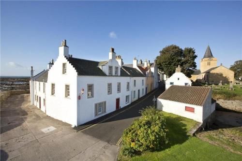a group of white buildings in a village at Merchants House- stunning seaview period home in Anstruther