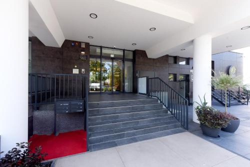 a building with stairs and a red carpet at M-Pire Hotel Berlin in Berlin