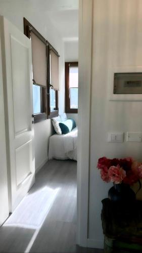 a living room with a couch and an open door at Agriturismo Borgo Rurale San Salvador-Casa del Maestro in Torre di Mosto