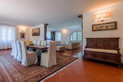 a dining room with a table and chairs and a living room at Villa Nina 12 in Pesaro