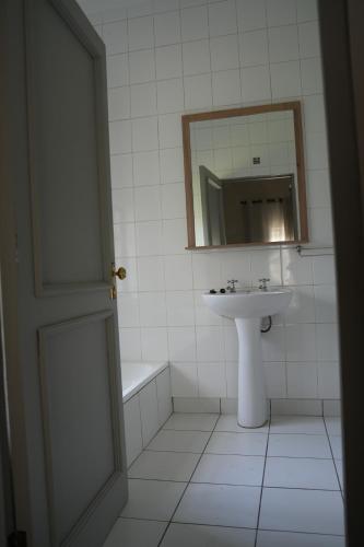 a white bathroom with a sink and a mirror at iNkosi Luxury Lodge in Parow