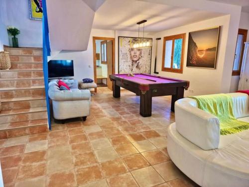 a living room with a pool table and chairs at VILLA SOFIA in Valldemossa