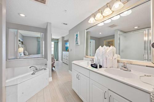 a bathroom with two sinks and a large mirror at Luxury 20th Floor 2 BR Condo Direct Oceanfront Wyndham Ocean Walk Resort Daytona Beach | 2027 in Daytona Beach