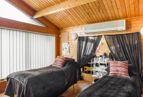 a bedroom with two beds and a air conditioner at Pine Lake Resort in Carnforth