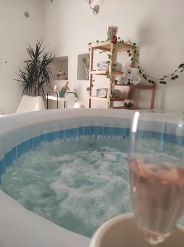 a hot tub with a glass of water in it at Affittacamere Silvagni in Caserta