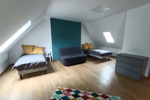 a attic bedroom with a bed and a chair at Gîte pour 9 personnes avec jardin à proximité du Puy Mary in Le Claux