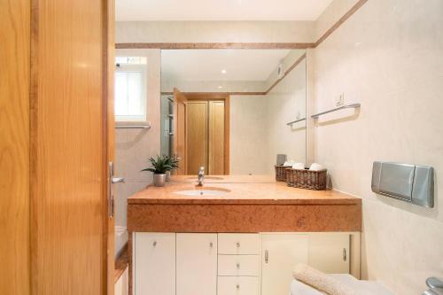 a bathroom with a sink and a mirror at Vilamoura Marina in Vilamoura