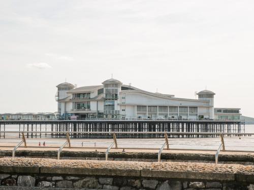 a building on the beach with a pier at The Nest in Bridgwater