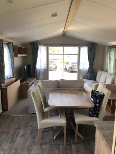 a living room with a table and a couch at Beach house fun in Walton-on-the-Naze