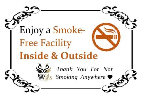 a sign that says enjoy a smoke free facility inside and outside at B&B Royal Swans in Bruges