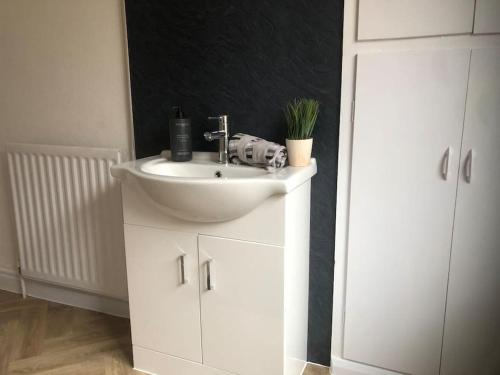 a bathroom with a white sink and a mirror at 15 Comfort House 2 bed townhouse with parking in Scunthorpe