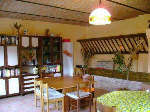 a dining room with a wooden table and chairs at B&B Locanda della Sesta Felicità in Vaglio Serra
