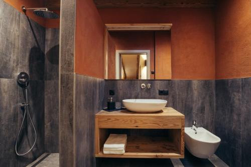 a bathroom with a sink and a mirror at Obertimpflerhof Wohnung Lola in Verano