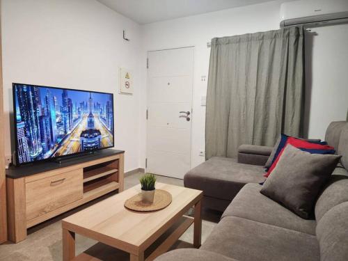 a living room with a couch and a flat screen tv at Piso de diseño Elche in Elche