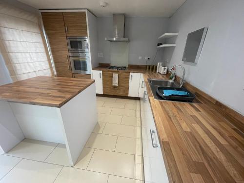 a kitchen with a sink and a counter top at Holiday Home In Cardiff, Sleeps 8 in Cardiff
