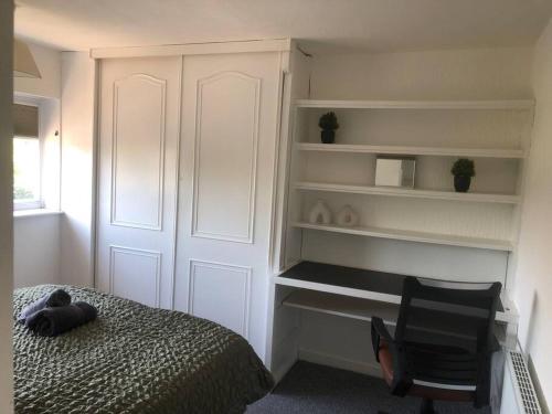 a bedroom with a bed and a chair and shelves at Bellingham house 3 bedroom home in Brumby