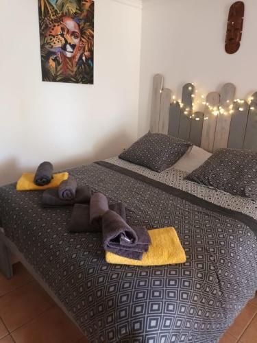 two beds with towels sitting on top of them at AT HOME studio rénové près de la plage in Sainte-Anne