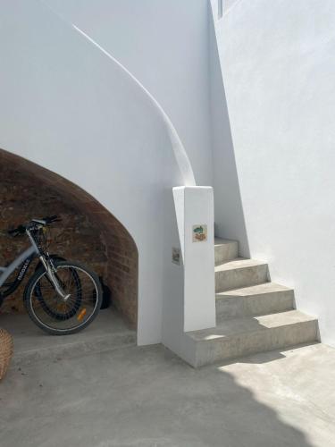a bicycle is parked next to a stairway at Grândola Suites - Suite Loft in Grândola