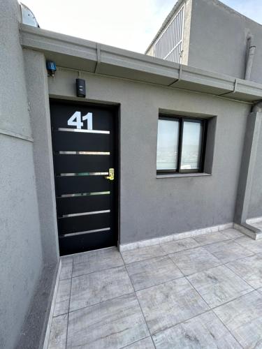 a garage door with the number on it at Terrazas del Fortín in San Salvador de Jujuy