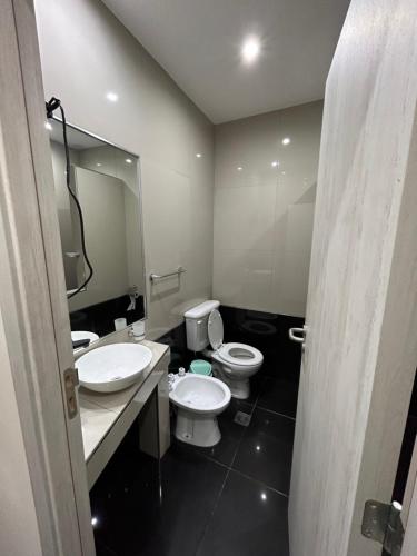 a bathroom with two toilets and a large mirror at Terrazas del Fortín in San Salvador de Jujuy