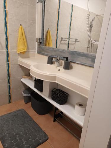 a bathroom with a sink and a mirror at AT HOME studio rénové près de la plage in Sainte-Anne