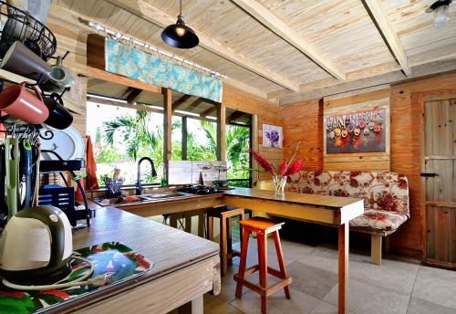 a kitchen with a table and a couch in a room at Cabarete Boutique Kite Hotel for up to 15 people in Cabarete