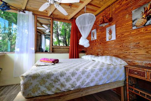 a bedroom with a bed and a wooden wall at Cabarete Boutique Kite Hotel for up to 15 people in Cabarete