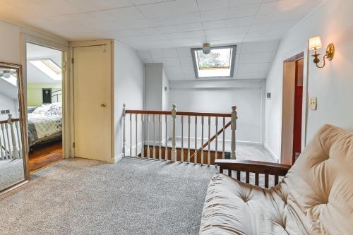a living room with a couch and a bed at Canandaigua Getaway with Deck and Sunroom! in Canandaigua