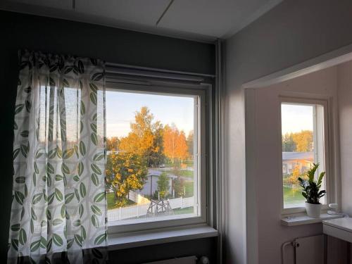a window in a room with a view of a yard at A stylish, newly decorated home! in Raahe