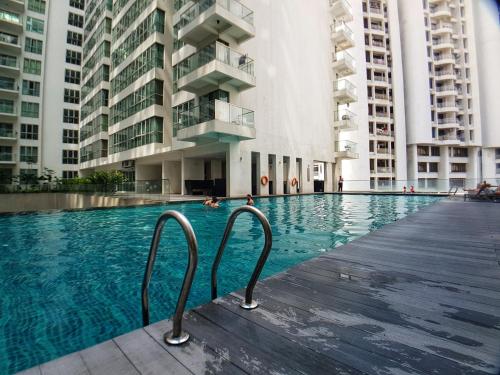 a swimming pool in a building with tall buildings at KL city 2 room in Regalia suites @ KLCC view infinity pool in Kuala Lumpur