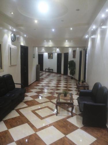 a large lobby with couches and a table in a building at Hotel Room with Breakfast -Beni sweif in Beni Suef