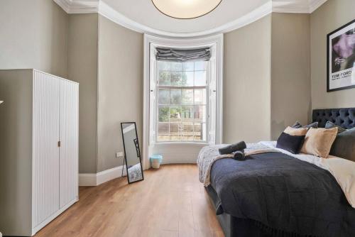 a bedroom with a bed and a large window at Stunning Central Wakefield Apartment 2 - Parking in Wakefield
