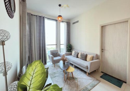 a living room with a couch and a table at Letstay - Misty Rosa 1BR Apartment in Dania 3 With Balcony in Dubai
