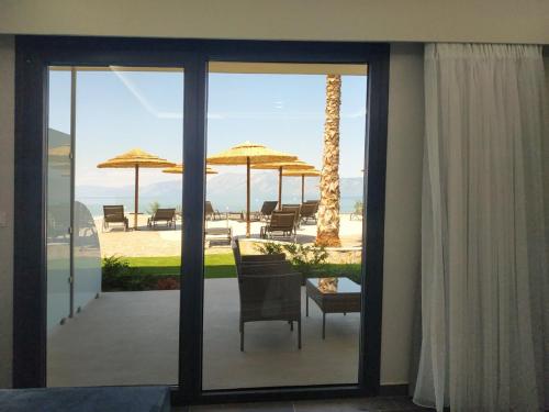 a view of a patio with a table and umbrellas at Anthidon Nature Estate & Farm in Chalkida