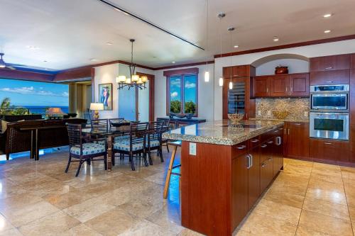 a kitchen and dining room with a table and chairs at Wailea Beach Villas M312 condo in Wailea